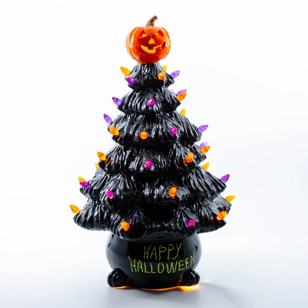 Black Halloween tree with a jack-o'-lantern topper and multicolored lights, set in a glossy black pot reading 'Happy Halloween' in lime green.